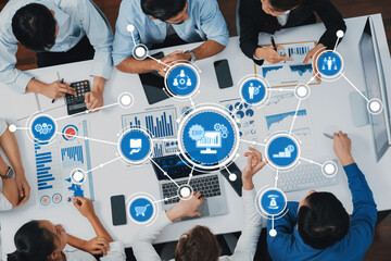 A diverse team engages in business analytics focused on ERP systems. They analyze data visualizations and collaborate using digital tools to drive strategic decisions. Amity