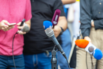 Journalists with microphones at press conference or media event