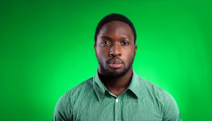 Fototapeta premium Man Facing Camera in Green Screen Studio