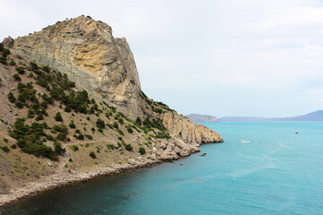 Fototapeta premium Rocky coastline meeting turquoise waters in crimea