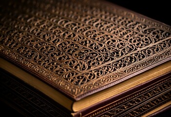 Fototapeta premium A close up of an ornate book on a black background.