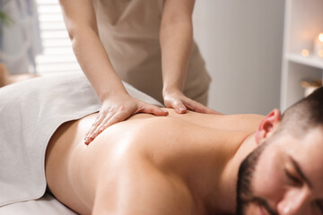 Fototapeta premium Man receiving relaxing massage in spa salon