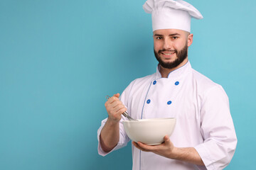 Happy confectioner in uniform holding whisk and bowl on light blue background