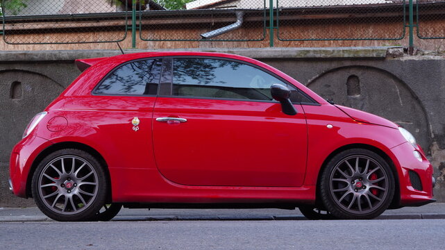 Bucharest, Romania &ndash; April 16, 2025: Side view of Abarth 695 Tributo Ferrari red car parked on street