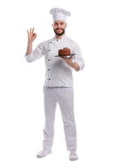 Happy confectioner in uniform holding delicious chocolate cake and showing ok gesture on white background