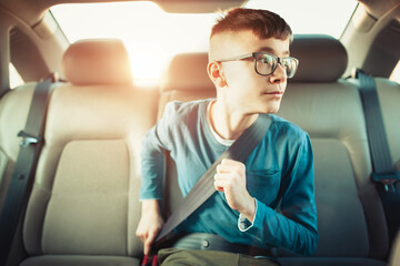 Child buckling seatbelt in car interior for safety