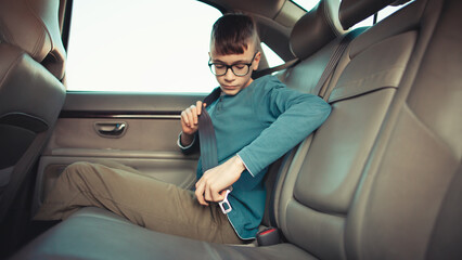 Child buckling seatbelt in car interior for safety