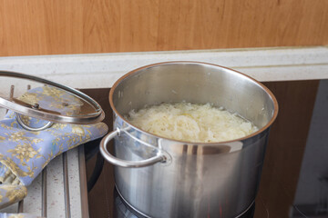 Boiled cabbage and fried onion in a pan