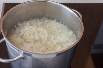 Boiled cabbage and fried onion in a pan