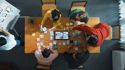 Top view of developer team working together to write idea about Ux Ui design on whiteboard. Smart...