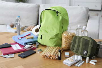 Survival kit. Different emergency supplies on wooden table indoors