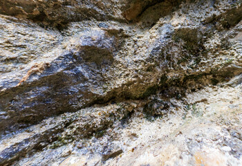 the walls of a stone gorge in a mountainous area, the structure of a geological section