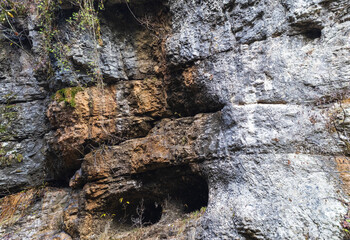 the walls of a stone gorge in a mountainous area, the structure of a geological section