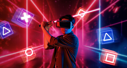 Gamer holding glowing laser sword and wearing augmented reality glasses while playing music game with glowing blue and red color. Energetic person VR glasses and connecting metaverse. Ingenuity.