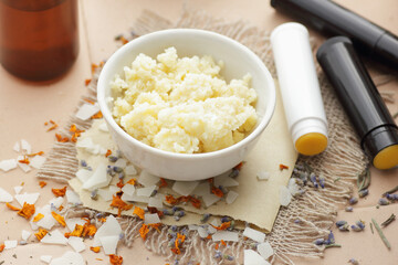 Shea butter in a bowl with cosmetic ingredients and diy lip balms