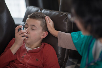 Pediatric asthma – little boy with inhaler at home