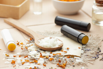 Emulsifier in a wooden spoon with cosmetic ingredients and diy lip balms