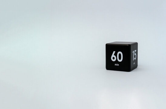 Black cube timer with 60 end 15 minutes sign on grey background. Minimal interval time concept. Selective focus and copy space