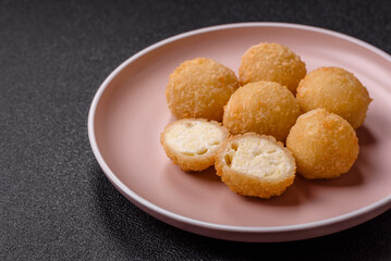 Cheese fried balls or croquettes with potatoes or rice