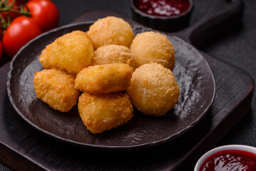 Fried mozzarella or brie cheese with cranberry or raspberry sauce