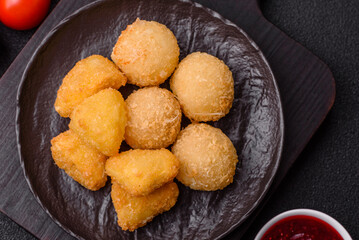 Fried mozzarella or brie cheese with cranberry or raspberry sauce
