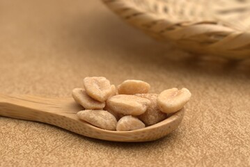 Peanuts, granola, and roasted nuts on neutral background – healthy snack and protein source