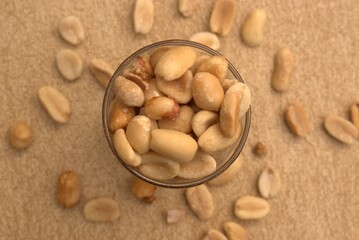 Peanuts, granola, and roasted nuts on neutral background – healthy snack and protein source