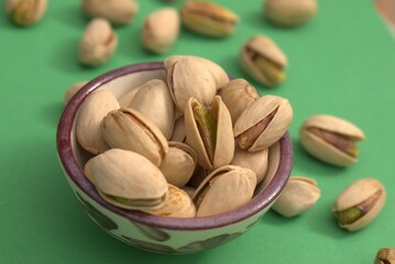 Pistachios on colorful backgrounds – healthy natural snack and vegan protein source