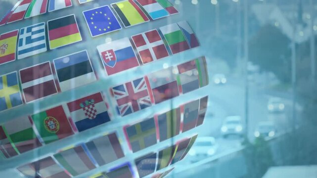 Digital globe being rotated with European flag icons in 3D render, showing moving highway scene