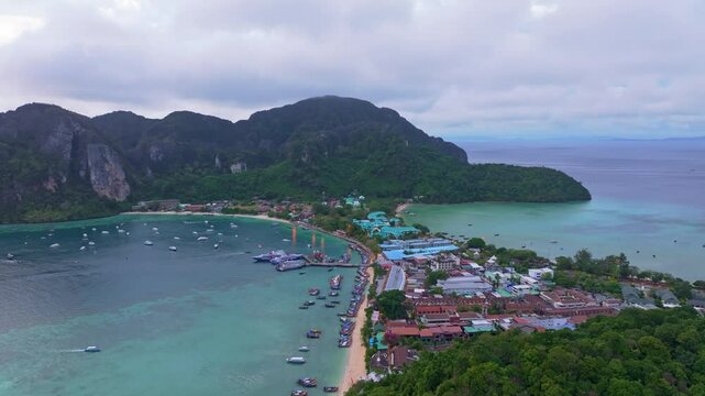 Luxury hotels and resorts dominate Phi Phi island, Thailand. Aerial drone video