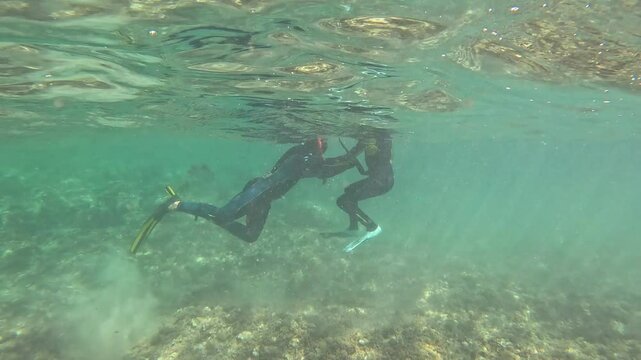 Father and his son fishing octopus in the Mediterranean Sea Moraira Spain