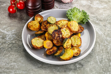 Roasted young zucchini in the plate