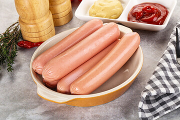 Boiled sausages with ketchup and mustard