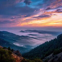 Fototapeta premium A serene mountain landscape at dawn, with mist covering the valleys and a colorful sky. 