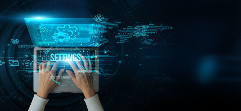 Man using a laptop with the Settings on the keyboard to analyze and develop system configuration options preferences customization adjustments parameters controls personalization setup management.