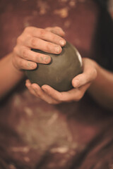 Pottery artist making a shape from clay. Shallow DOF. Developed from RAW; retouched with special...