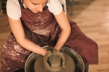 Pottery artist making a shape from clay. Shallow DOF. Developed from RAW; retouched with special...