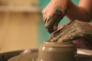 Pottery artist making a shape from clay. Shallow DOF. Developed from RAW; retouched with special care and attention; Small amount of grain added for best final impression. 