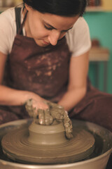 Pottery artist making a shape from clay. Shallow DOF. Developed from RAW; retouched with special...