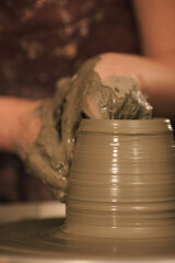 Pottery artist making a shape from clay. Shallow DOF. Developed from RAW; retouched with special...
