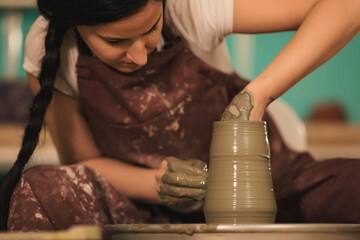 Pottery artist making a shape from clay. Shallow DOF. Developed from RAW; retouched with special...