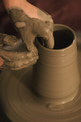Pottery artist making a shape from clay. Shallow DOF. Developed from RAW; retouched with special...
