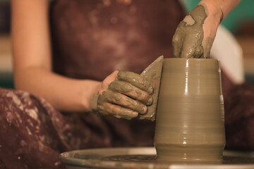 Pottery artist making a shape from clay. Shallow DOF. Developed from RAW; retouched with special...