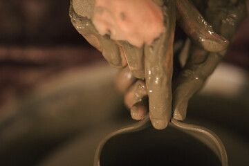 Pottery artist making a shape from clay. Shallow DOF. Developed from RAW; retouched with special...