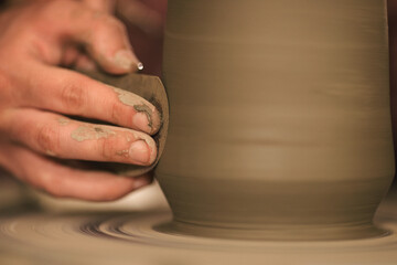 Pottery artist making a shape from clay. Shallow DOF. Developed from RAW; retouched with special...