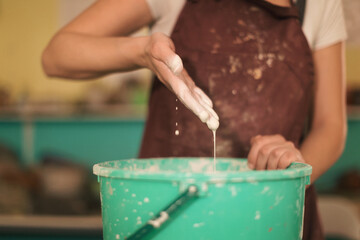 Pottery artist making a shape from clay. Shallow DOF. Developed from RAW; retouched with special...