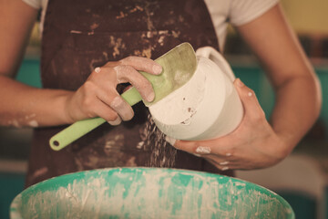 Pottery artist making a shape from clay. Shallow DOF. Developed from RAW; retouched with special...
