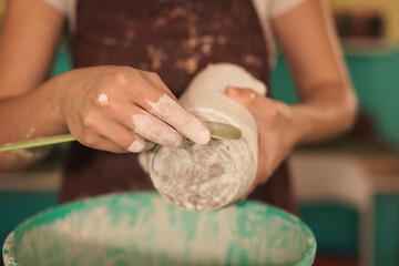 Pottery artist making a shape from clay. Shallow DOF. Developed from RAW; retouched with special...