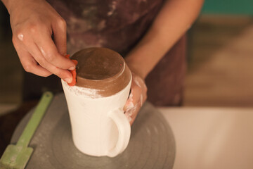 Pottery artist making a shape from clay. Shallow DOF. Developed from RAW; retouched with special...