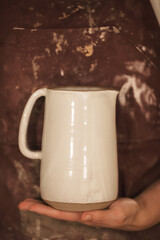 Pottery artist making a shape from clay. Shallow DOF. Developed from RAW; retouched with special care and attention; Small amount of grain added for best final impression. 